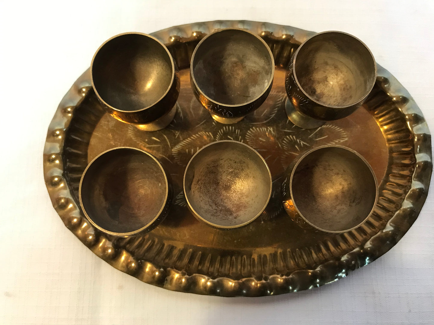 Mini brass drinking cups on tray