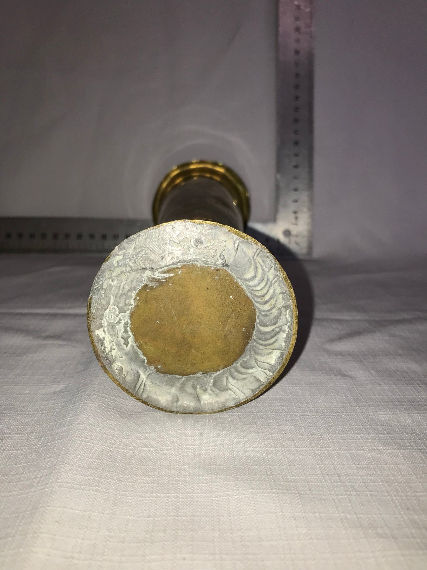 Tall brass vase with dents for character