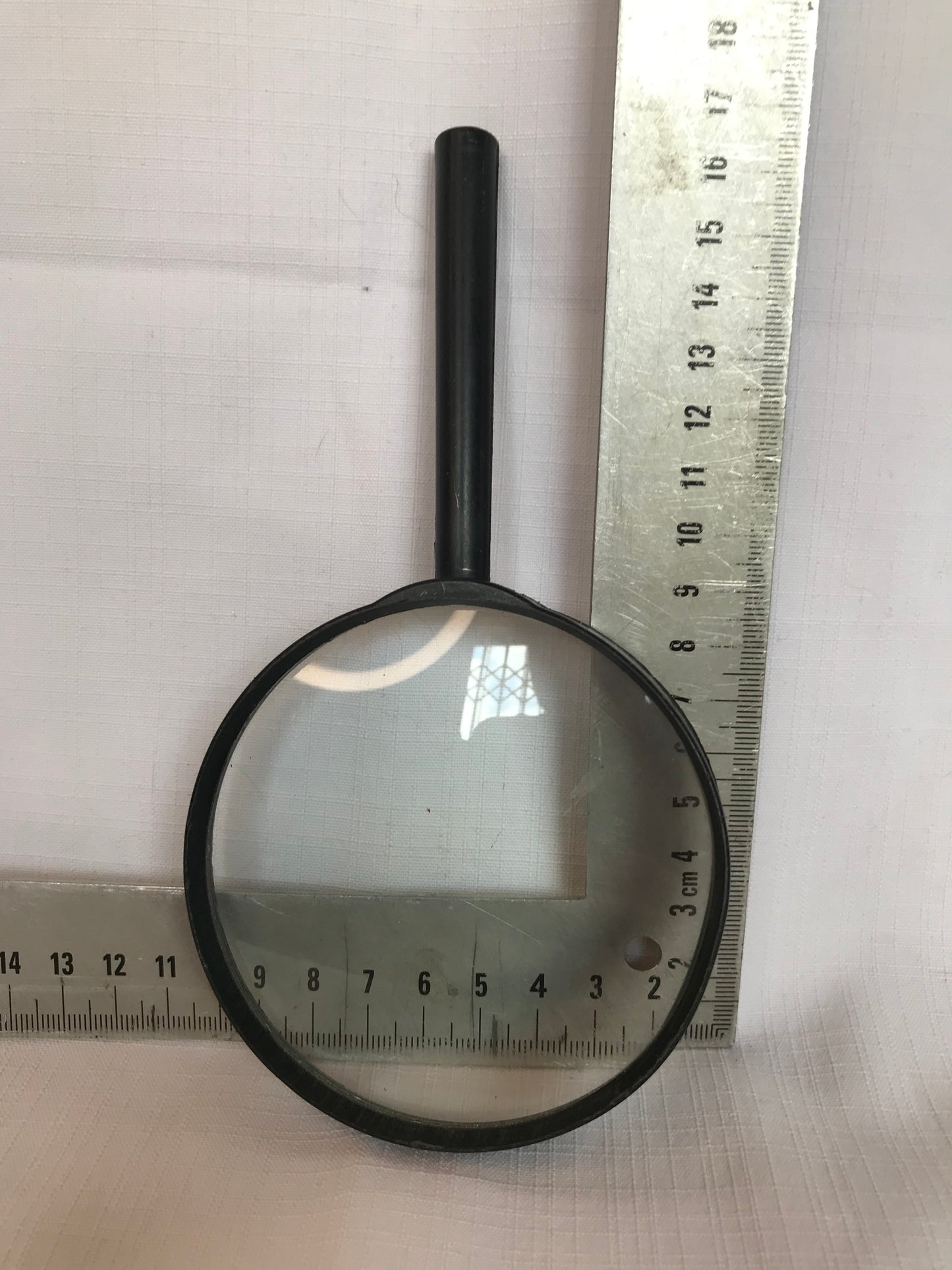 Magnifying glass with black plastic rim