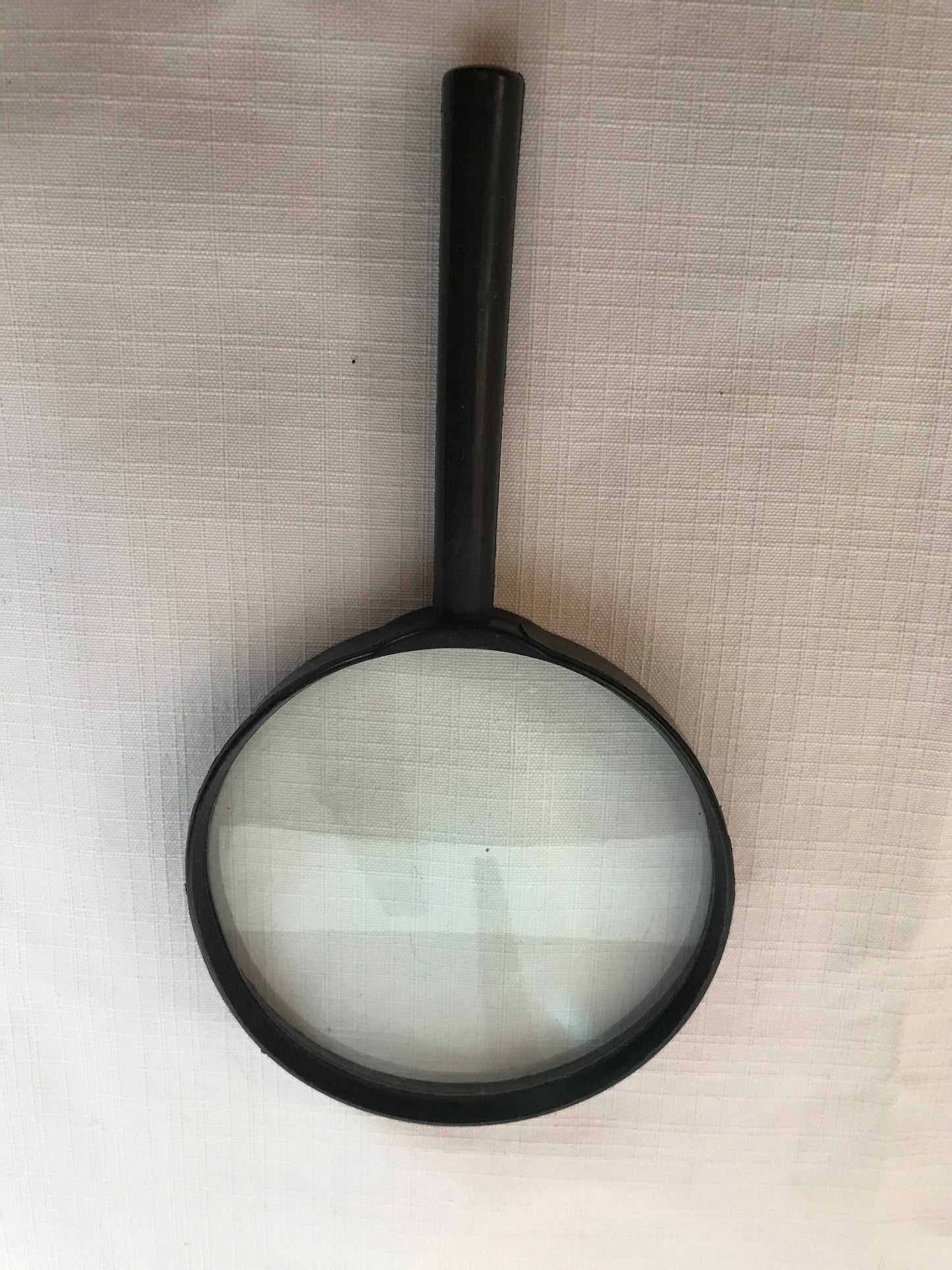 Magnifying glass with black plastic rim