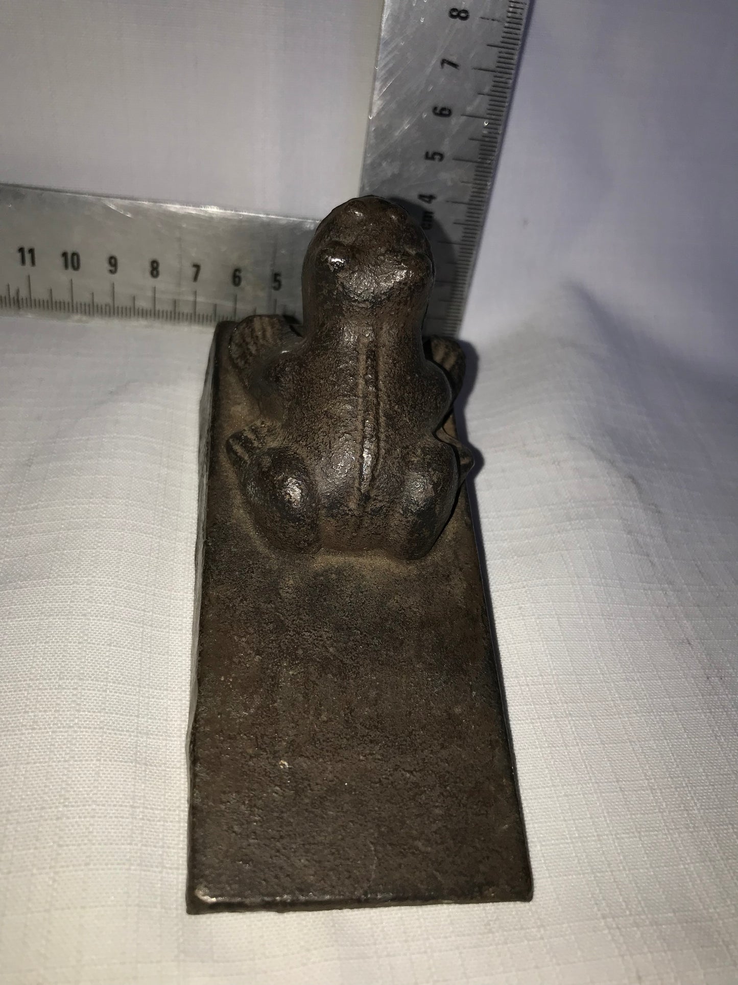 Heavy metal frog door stop