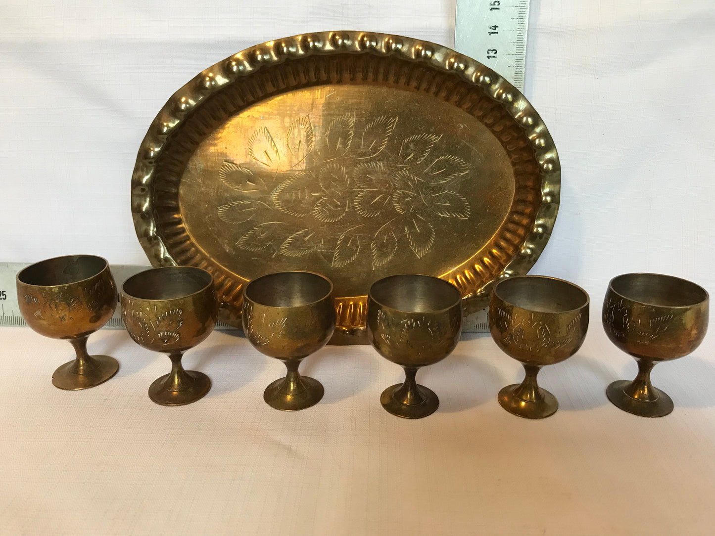 Mini brass drinking cups on tray