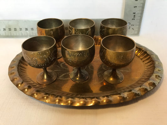 Mini brass drinking cups on tray