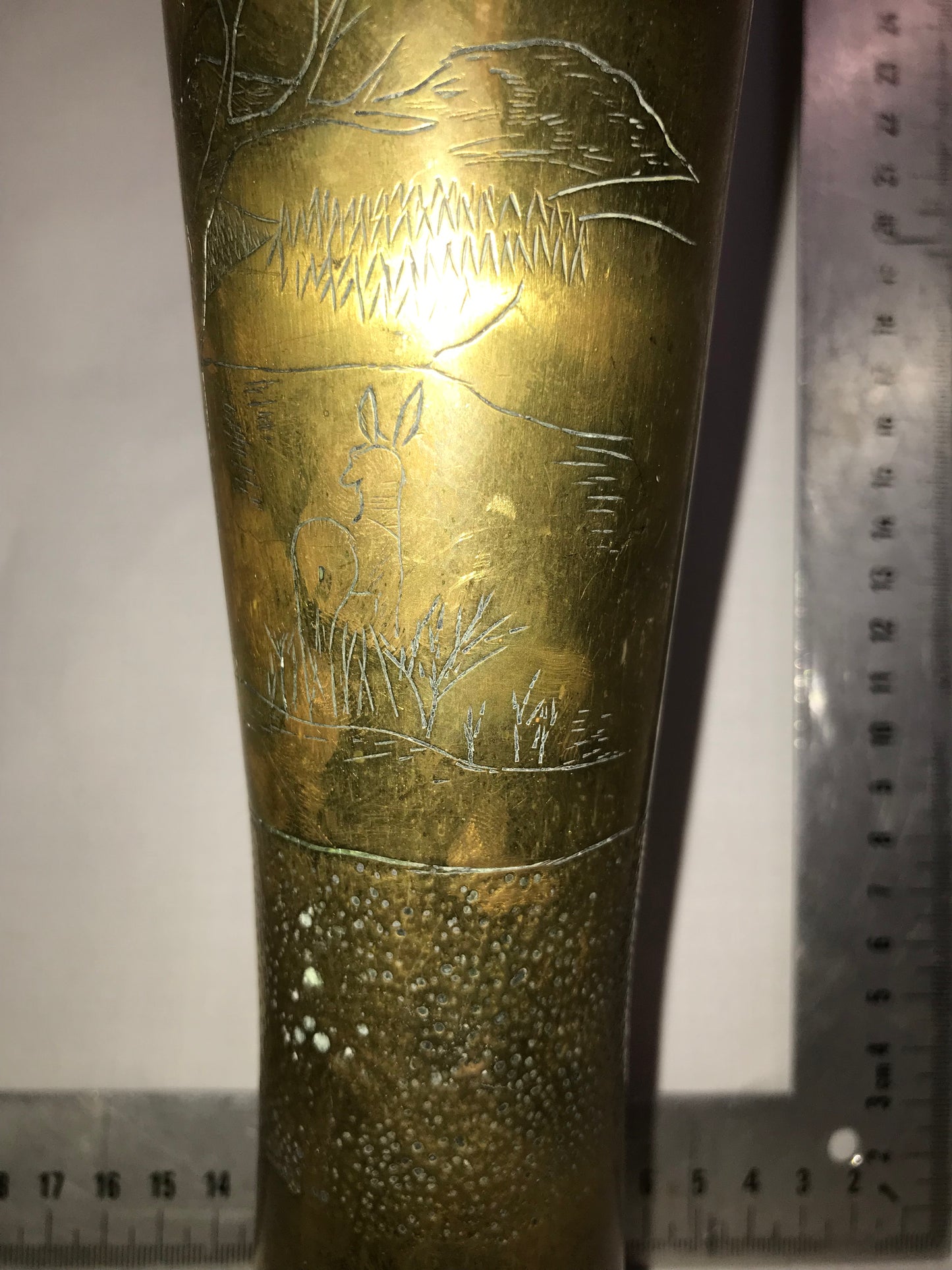 Tall brass vase with dents for character