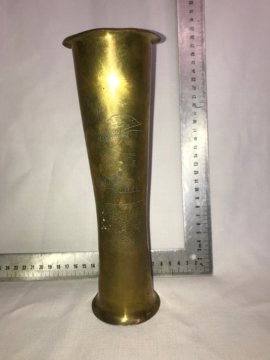 Tall brass vase with dents for character