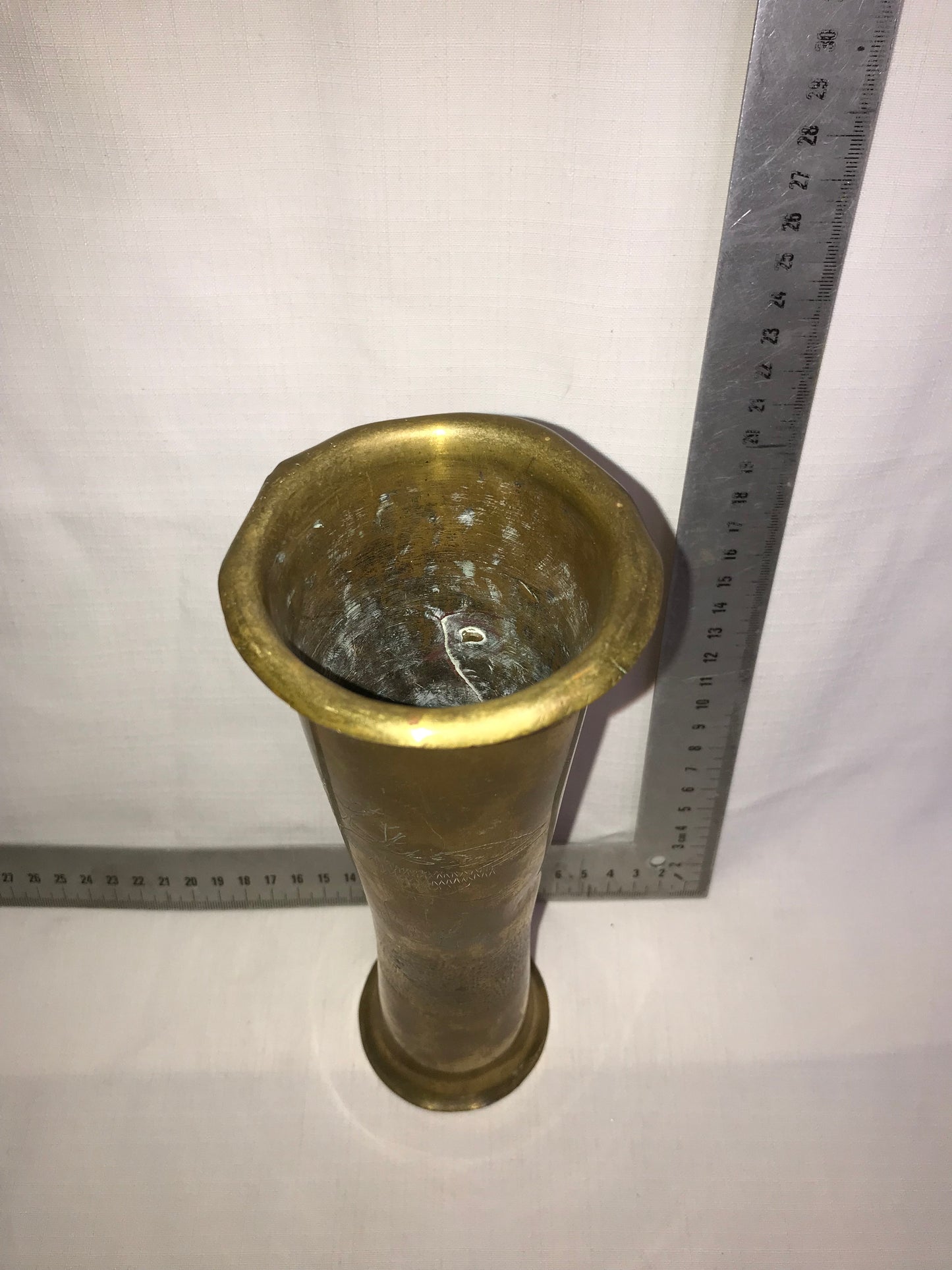 Tall brass vase with dents for character
