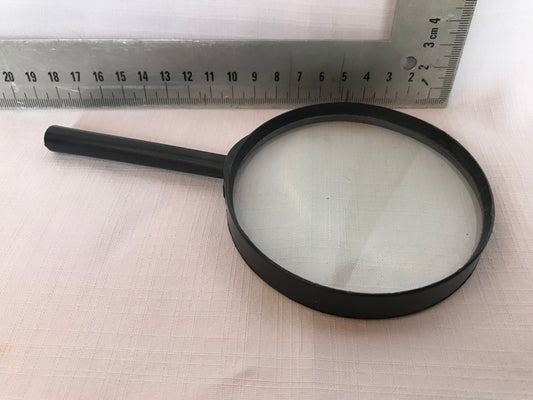 Magnifying glass with black plastic rim